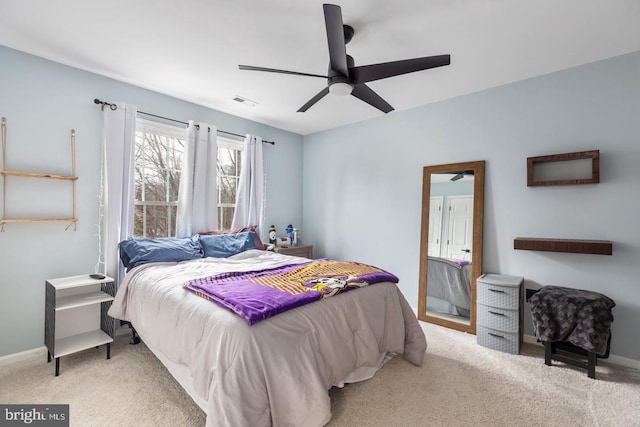 carpeted bedroom with visible vents, ceiling fan, and baseboards