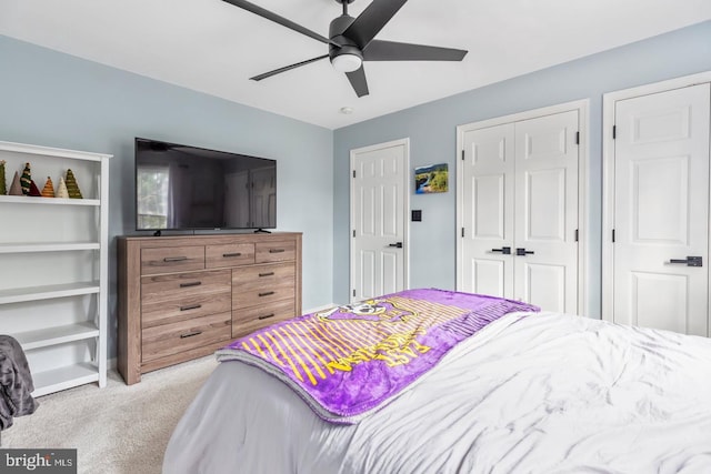 carpeted bedroom featuring a closet and ceiling fan