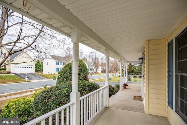 view of patio featuring covered porch and a residential view