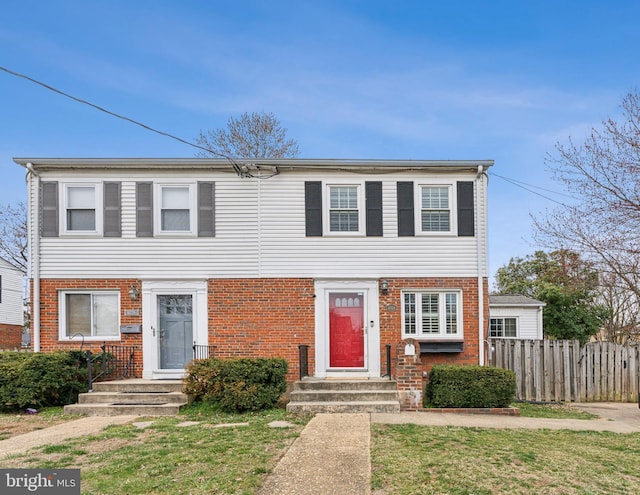 multi unit property with brick siding and fence