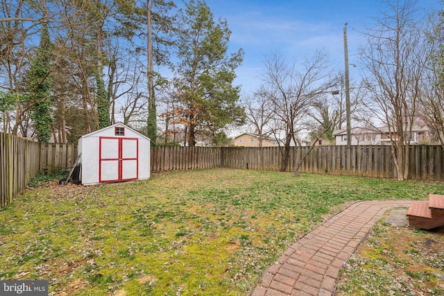 view of yard with an outbuilding, a storage shed, and a fenced backyard