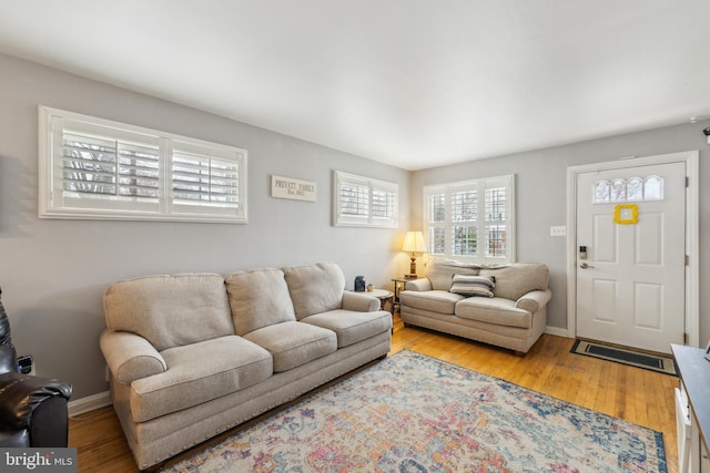 living room featuring light wood-style flooring and baseboards