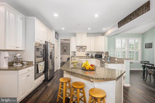 10437 Windlass Run Rd, Baltimore, MD 21220 - kitchen featuring decorative backsplash, appliances with stainless steel finishes, a peninsula, and dark wood-style floors