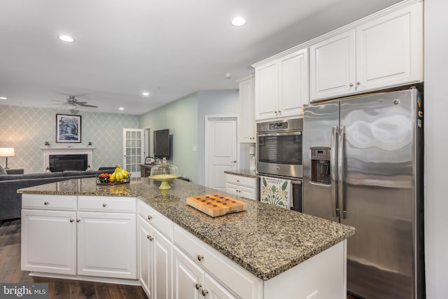 10437 Windlass Run Rd, Baltimore, MD 21220 - kitchen with dark wood-style flooring, white cabinetry, dark stone counters, ceiling fan, and appliances with stainless steel finishes