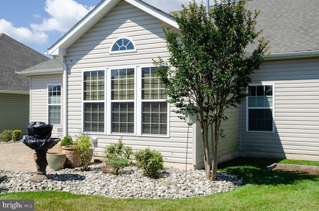 view of side of home featuring a shingled roof