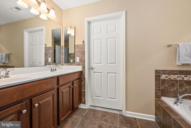 full bath with double vanity, visible vents, a garden tub, and a sink