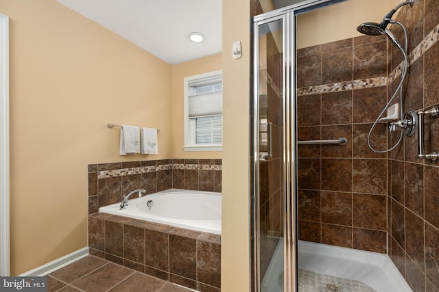 bathroom with tile patterned flooring, a garden tub, and a stall shower