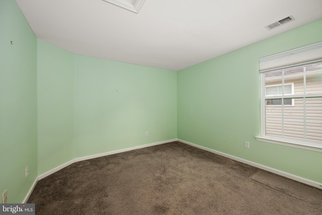 spare room featuring visible vents, carpet floors, and baseboards