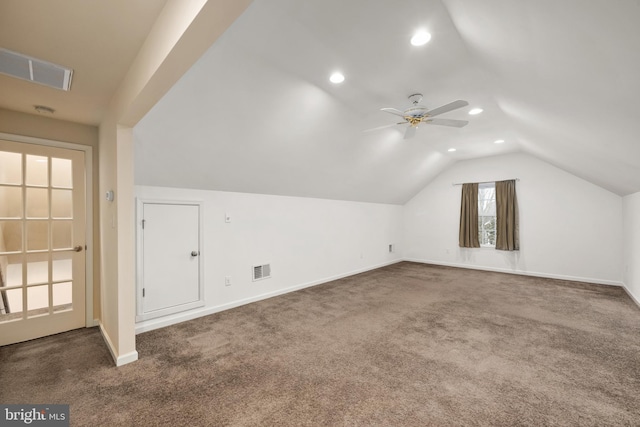 additional living space featuring lofted ceiling, carpet flooring, baseboards, and visible vents