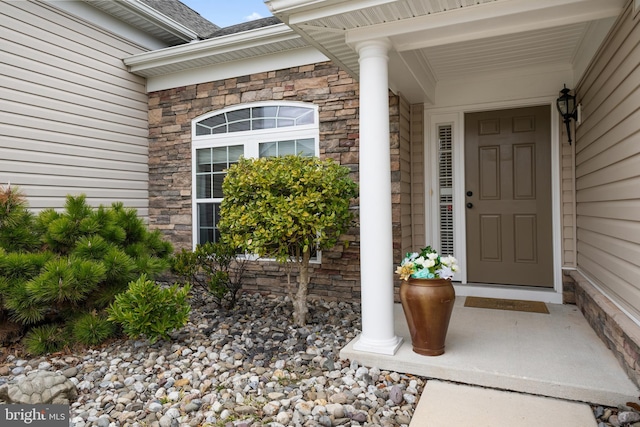 property entrance with stone siding