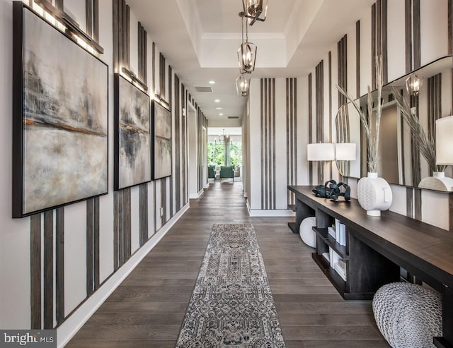 hallway with visible vents, crown molding, recessed lighting, dark wood-style floors, and a raised ceiling