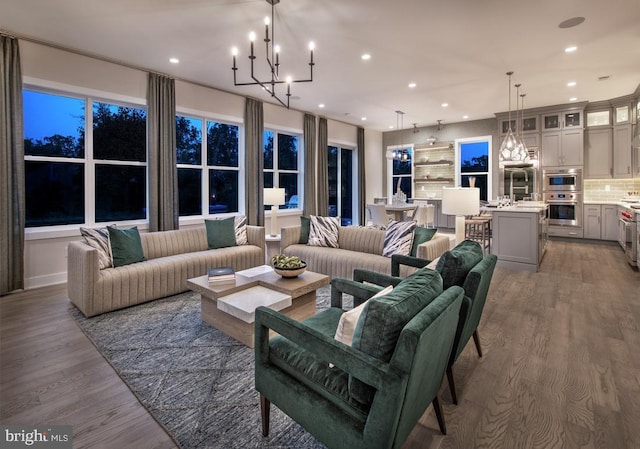 living room featuring light wood-style flooring, recessed lighting, and a chandelier