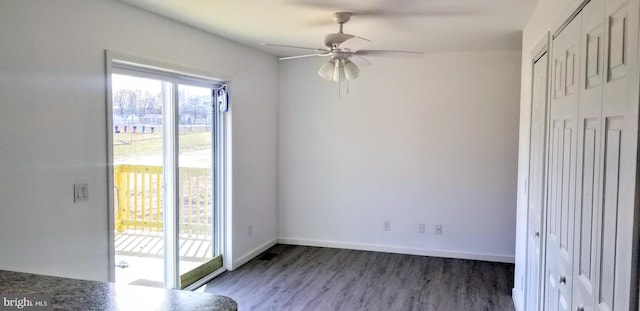 interior space with baseboards, ceiling fan, and wood finished floors