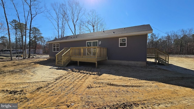 back of house featuring a wooden deck