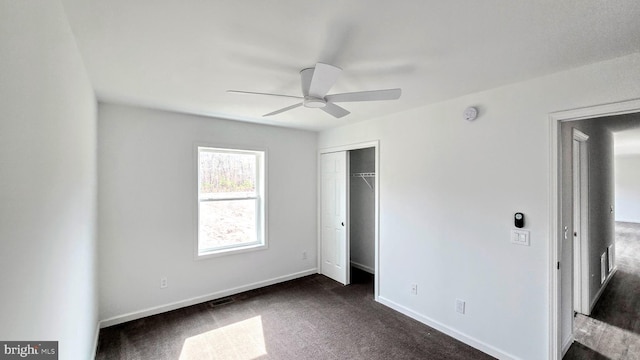 unfurnished bedroom featuring a ceiling fan, visible vents, baseboards, carpet floors, and a closet