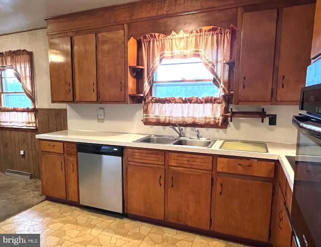 kitchen with a sink, light countertops, visible vents, and stainless steel dishwasher