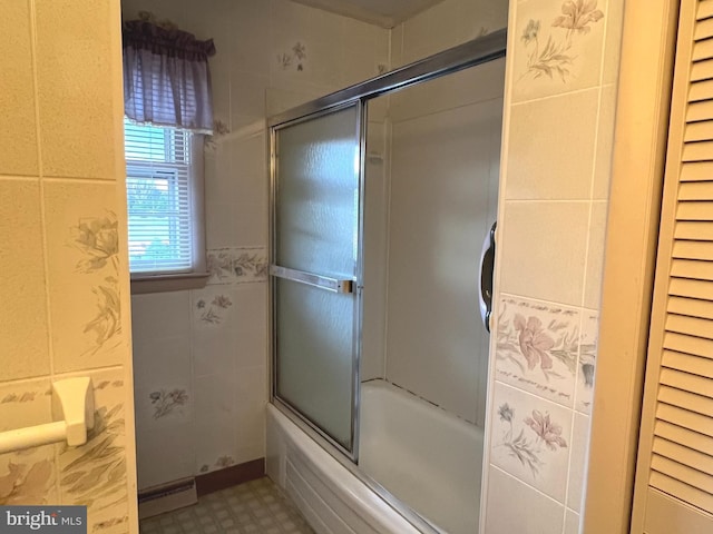 bathroom with tile patterned floors, a baseboard radiator, and combined bath / shower with glass door