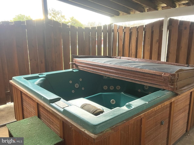 misc room with wooden walls and a hot tub
