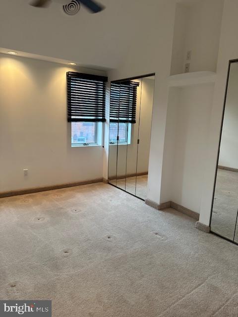 unfurnished bedroom with carpet and baseboards