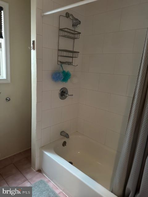 bathroom featuring tile patterned floors and shower / bathtub combination with curtain