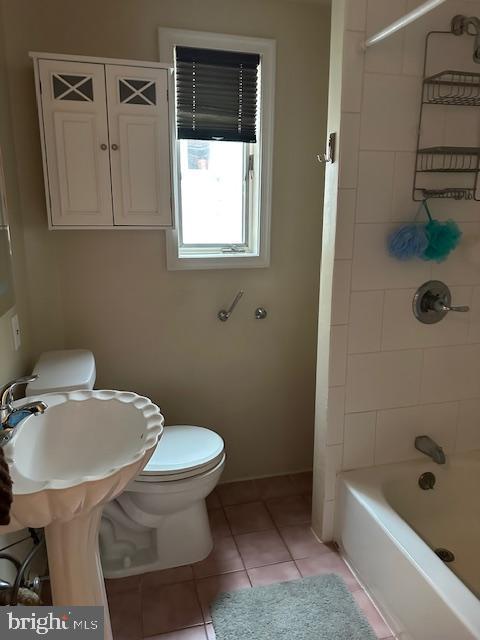 bathroom with tile patterned floors, toilet, and shower / tub combination