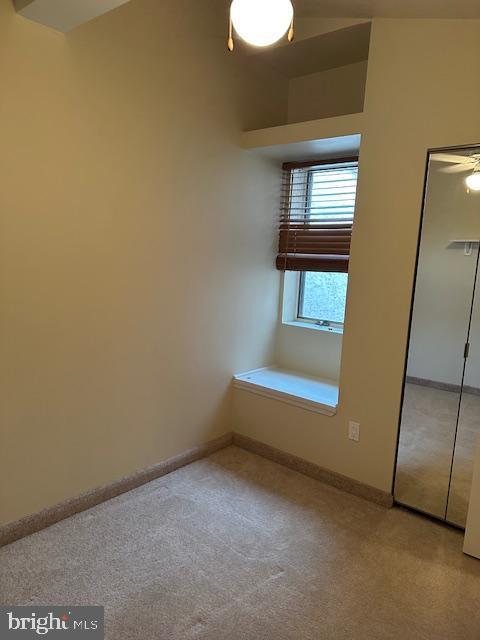 unfurnished bedroom with carpet flooring, baseboards, and a closet