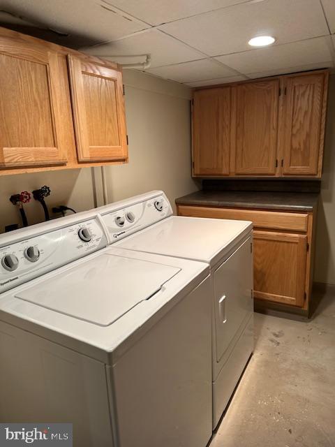 washroom featuring washer and dryer and cabinet space