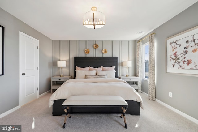 bedroom with visible vents, light carpet, and baseboards