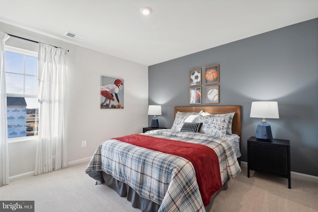 bedroom featuring visible vents, multiple windows, carpet, and baseboards