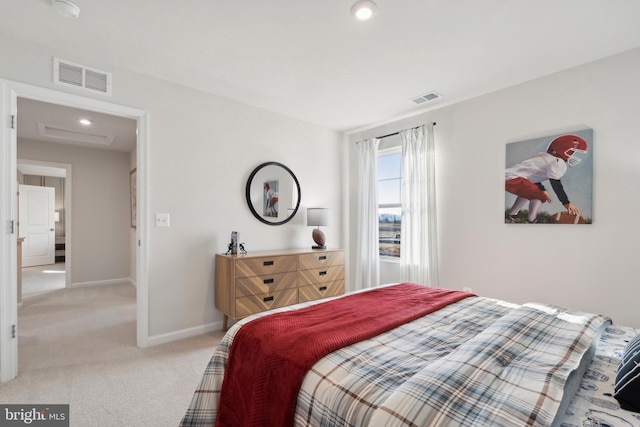 bedroom featuring visible vents, light colored carpet, and baseboards