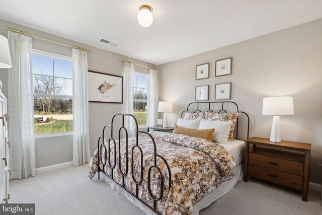 carpeted bedroom featuring visible vents and baseboards