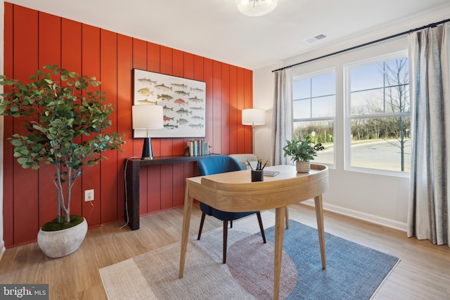 office area featuring visible vents, baseboards, and light wood-style floors