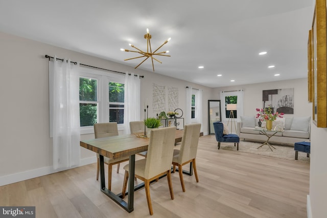 dining space with baseboards, recessed lighting, light wood-type flooring, and a chandelier