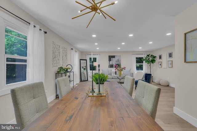 dining room featuring recessed lighting, wood finished floors, baseboards, and a chandelier