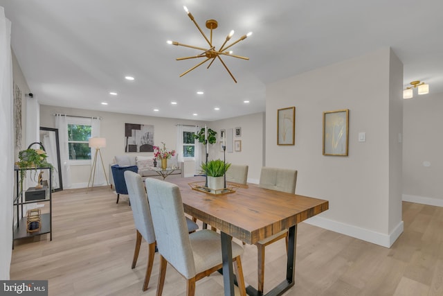 dining room featuring recessed lighting, baseboards, light wood finished floors, and a chandelier