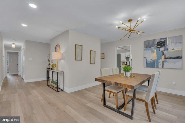 dining room featuring a chandelier, recessed lighting, baseboards, and light wood-style floors