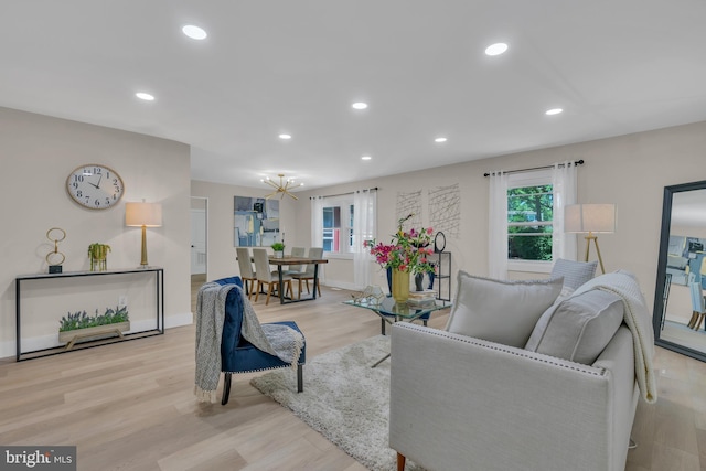 living room with a notable chandelier, recessed lighting, baseboards, and wood finished floors