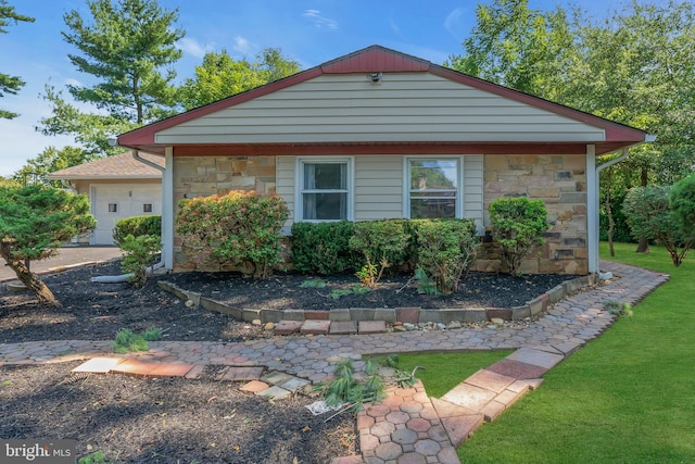 view of front facade with a garage and stone siding