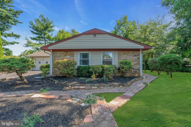 view of front of house featuring stone siding, a garage, and a front lawn