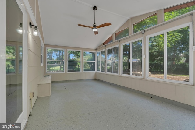 unfurnished sunroom with a healthy amount of sunlight, lofted ceiling, and ceiling fan