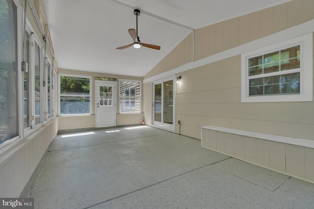 unfurnished sunroom with a ceiling fan and vaulted ceiling