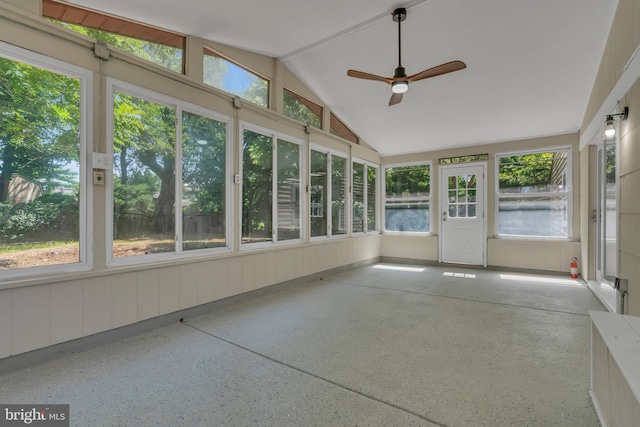 unfurnished sunroom with a ceiling fan and vaulted ceiling