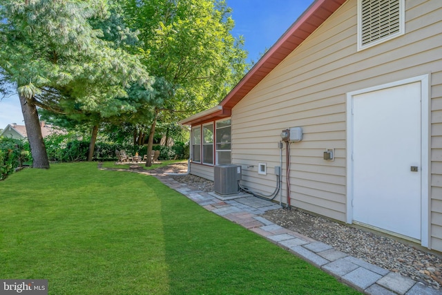 view of yard with a patio, central AC, and a sunroom