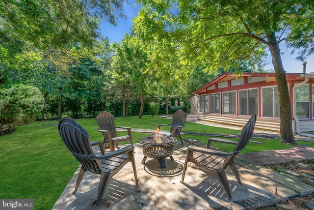 view of patio / terrace with entry steps and a fire pit