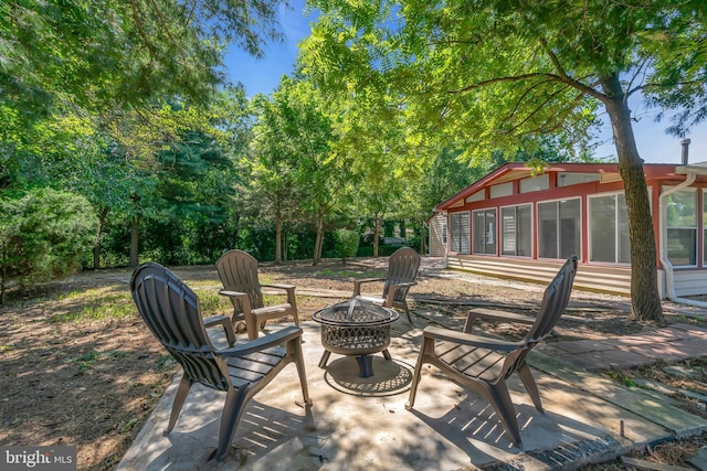 view of patio featuring entry steps and an outdoor fire pit