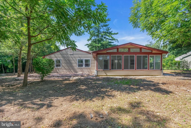 rear view of property with a sunroom