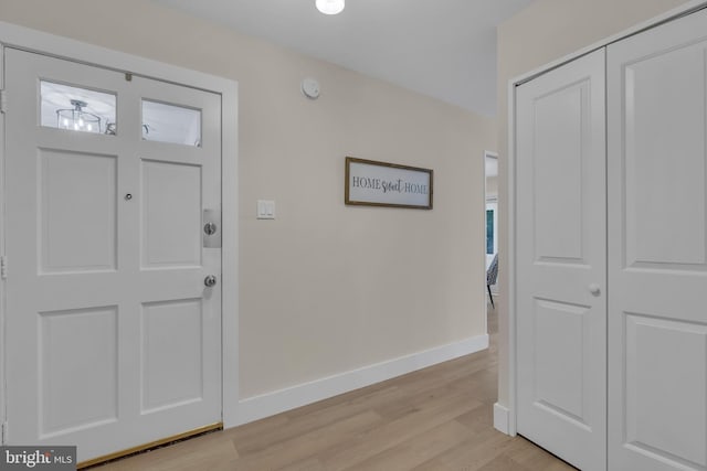 entryway with baseboards and light wood-style floors