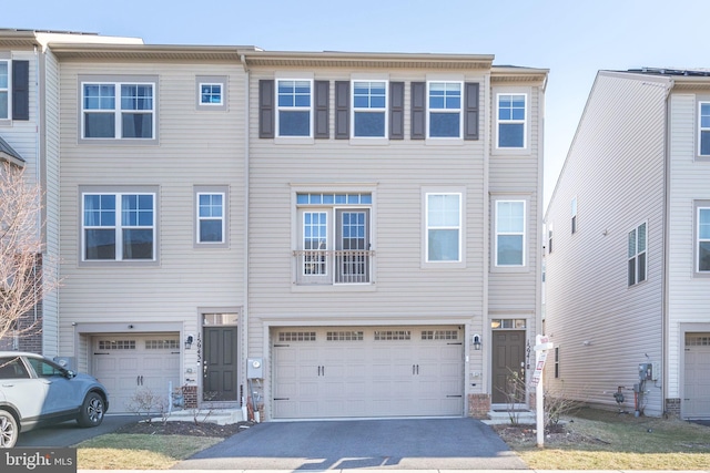 view of front of property featuring aphalt driveway and an attached garage