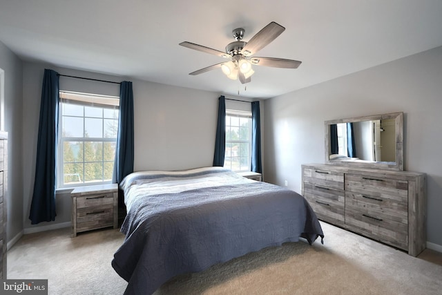 carpeted bedroom with baseboards and ceiling fan