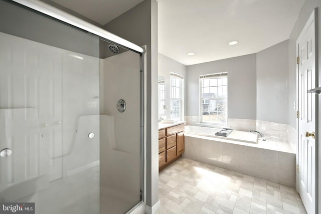 full bathroom featuring recessed lighting, a stall shower, vanity, and a garden tub